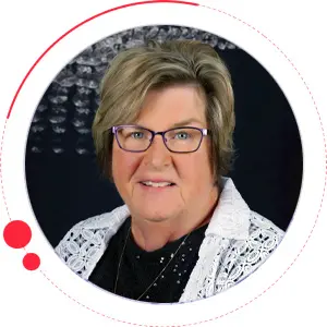 Friendly woman with glasses and white lace top - Looney Bin Quilting