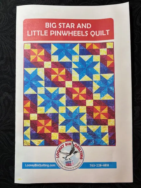 Big Star and Little Pinwheels Quilt Pattern: Vibrant quilt design with large stars and small pinwheels in blue, red, yellow, and purple. - Looney Bin Quilting